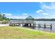 Lakeside view of pier with covered seating, offering serene water views at 4302 Longfellow Dr, Plant City, FL 33566