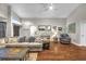 Comfortable living room featuring a plush sectional sofa, hardwood floors, and a vaulted ceiling at 4302 Longfellow Dr, Plant City, FL 33566