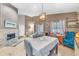Comfortable living room features a stone fireplace, tile flooring, and a pendant light above the dining table at 4302 Longfellow Dr, Plant City, FL 33566