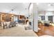 Open-concept living space featuring hardwood floors, living room, kitchen, dining area, and a stone fireplace at 4302 Longfellow Dr, Plant City, FL 33566