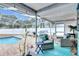 Screened-in patio with cushioned seating and a tranquil view of the pool at 4302 Longfellow Dr, Plant City, FL 33566
