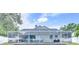 Backyard view of pool enclosed with a screen surrounded by lush foliage at 4302 Longfellow Dr, Plant City, FL 33566