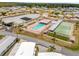 Aerial view of a retirement community featuring a swimming pool, shuffleboard, and clubhouse at 4314 12Th Street E Ct, Ellenton, FL 34222