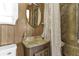 This bathroom features a vintage-style sink with a wooden cabinet and a shower with curtain at 4314 12Th Street E Ct, Ellenton, FL 34222