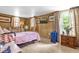 Bedroom featuring wood paneling, furniture, and a door leading to the outside at 4314 12Th Street E Ct, Ellenton, FL 34222
