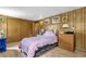 Bedroom with warm wood paneling, closet, and bed offers a cozy atmosphere at 4314 12Th Street E Ct, Ellenton, FL 34222