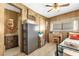Bedroom featuring a bed, a desk, a wardrobe, a window and an ensuite bathroom at 4314 12Th Street E Ct, Ellenton, FL 34222
