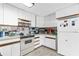Traditional kitchen with white cabinets and appliances, offering a functional cooking space at 4314 12Th Street E Ct, Ellenton, FL 34222