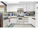 Functional kitchen with white cabinetry and laminate flooring, ready for updates at 4314 12Th Street E Ct, Ellenton, FL 34222