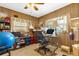 This office space features wood paneling, two windows, an office chair, and desk at 4314 12Th Street E Ct, Ellenton, FL 34222