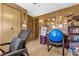 A view of an office featuring wood paneling, an office chair, a desk, and storage at 4314 12Th Street E Ct, Ellenton, FL 34222