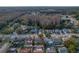 Aerial view of home with pool, patio, privacy fence, and mature trees at 5036 Glenhurst Ln, New Port Richey, FL 34653