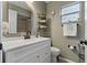 Bright bathroom with a vanity, updated hardware, shelving and a window at 5036 Glenhurst Ln, New Port Richey, FL 34653