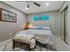 Comfortable bedroom with a ceiling fan, neutral colored walls, and an ensuite bathroom at 5036 Glenhurst Ln, New Port Richey, FL 34653