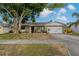 Charming single Gathering home with a well-maintained lawn and mature tree in a quiet neighborhood at 5036 Glenhurst Ln, New Port Richey, FL 34653