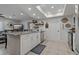 Bright and open kitchen with granite countertops, island seating, and modern stainless steel appliances at 5036 Glenhurst Ln, New Port Richey, FL 34653