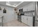 Well-equipped kitchen featuring white cabinetry, stainless steel appliances, and a stylish backsplash at 5036 Glenhurst Ln, New Port Richey, FL 34653