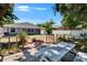 Backyard featuring a wooden deck with a picnic table, a well-maintained lawn, and a fenced perimeter at 5081 72Nd N Ave, Pinellas Park, FL 33781