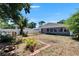 Backyard featuring manicured lawn, garden beds, a charming patio area and privacy fencing at 5081 72Nd N Ave, Pinellas Park, FL 33781