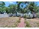 Backyard featuring manicured lawn, a charming patio area, mature shade trees and privacy fencing at 5081 72Nd N Ave, Pinellas Park, FL 33781