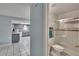 View from hallway into bathroom and kitchen featuring tile floors and walk-in shower at 5081 72Nd N Ave, Pinellas Park, FL 33781
