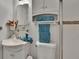 Cozy bathroom with vanity, toilet with turquoise towels, and overhead cabinet storage at 5081 72Nd N Ave, Pinellas Park, FL 33781