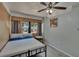 This bedroom showcases paneled walls, tile floor, and a bed with grey linens and blue trim at 5081 72Nd N Ave, Pinellas Park, FL 33781