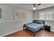 Bedroom featuring wood laminate flooring, a ceiling fan, light-filled window, and neutral wall color at 5081 72Nd N Ave, Pinellas Park, FL 33781
