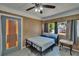 Bedroom featuring a gray tiled floor, paneled walls, and a bed with blue accents at 5081 72Nd N Ave, Pinellas Park, FL 33781