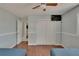 Cozy bedroom boasts hardwood floors, two beds, a closet, and a mounted television at 5081 72Nd N Ave, Pinellas Park, FL 33781