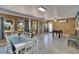 Spacious game room features a foosball table, dining table, gray tile flooring, and wood-paneled walls at 5081 72Nd N Ave, Pinellas Park, FL 33781