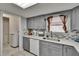 Bright kitchen featuring stainless steel sink, gray cabinets and easy access to laundry room at 5081 72Nd N Ave, Pinellas Park, FL 33781