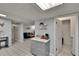 Open living space with tile floors, kitchen island, open door to laundry, and view into living room at 5081 72Nd N Ave, Pinellas Park, FL 33781