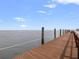 Wooden dock extending into the water with rope railings, offering a peaceful waterfront experience at 5191 Salmon Se Dr # C, St Petersburg, FL 33705