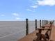 Waterfront wooden dock featuring benches overlooking a tranquil ocean view, perfect for relaxation at 5191 Salmon Se Dr # C, St Petersburg, FL 33705