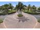 Circular brick paver driveway with palm tree landscaping and manicured greenery surrounding at 5191 Salmon Se Dr # C, St Petersburg, FL 33705