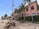 Community clubhouse exterior with brick patio, picnic tables, grills, and tropical landscaping at 5191 Salmon Se Dr # C, St Petersburg, FL 33705