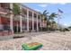 Clubhouse with brick patio, palm trees, American flag, and outdoor seating area at 5191 Salmon Se Dr # C, St Petersburg, FL 33705
