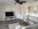 Bright living room with a ceiling fan, neutral tones, and stylish coastal decor at 5191 Salmon Se Dr # C, St Petersburg, FL 33705