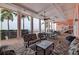 Covered patio with seating, dining area, staircase, and views of tropical landscaping at 5191 Salmon Se Dr # C, St Petersburg, FL 33705