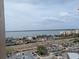 Elevated view of city with commercial area, water, and distant land under a partly cloudy sky at 5200 S Brittany S Dr # 1605, St Petersburg, FL 33715