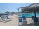 Inviting pool area with lounge chairs, umbrellas, and nearby complex at 5200 S Brittany S Dr # 1605, St Petersburg, FL 33715