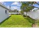 Lush green backyard with a well-maintained lawn and white vinyl fencing at 5235 42Nd S St, St Petersburg, FL 33711