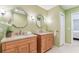 Bathroom features double sinks, granite counters, wood cabinets, and octagonal mirrors at 5235 42Nd S St, St Petersburg, FL 33711