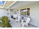Cozy front porch features seating, a welcome mat, stylish double doors, and lush landscaping at 5235 42Nd S St, St Petersburg, FL 33711