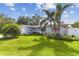 Charming single-story home with a manicured lawn and tropical landscaping at 5235 42Nd S St, St Petersburg, FL 33711