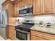 Kitchen with stainless steel appliances, granite counters, and wood cabinetry at 5235 42Nd S St, St Petersburg, FL 33711