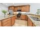 Kitchen featuring granite counters, stainless steel appliances, and ample wooden cabinet storage at 5235 42Nd S St, St Petersburg, FL 33711