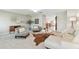 Open-concept living area with light tile floors, stylish furniture, and inviting decor leading to kitchen at 5235 42Nd S St, St Petersburg, FL 33711