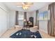 Study area featuring a cozy rug, large windows, chairs and ceiling fan at 5235 42Nd S St, St Petersburg, FL 33711